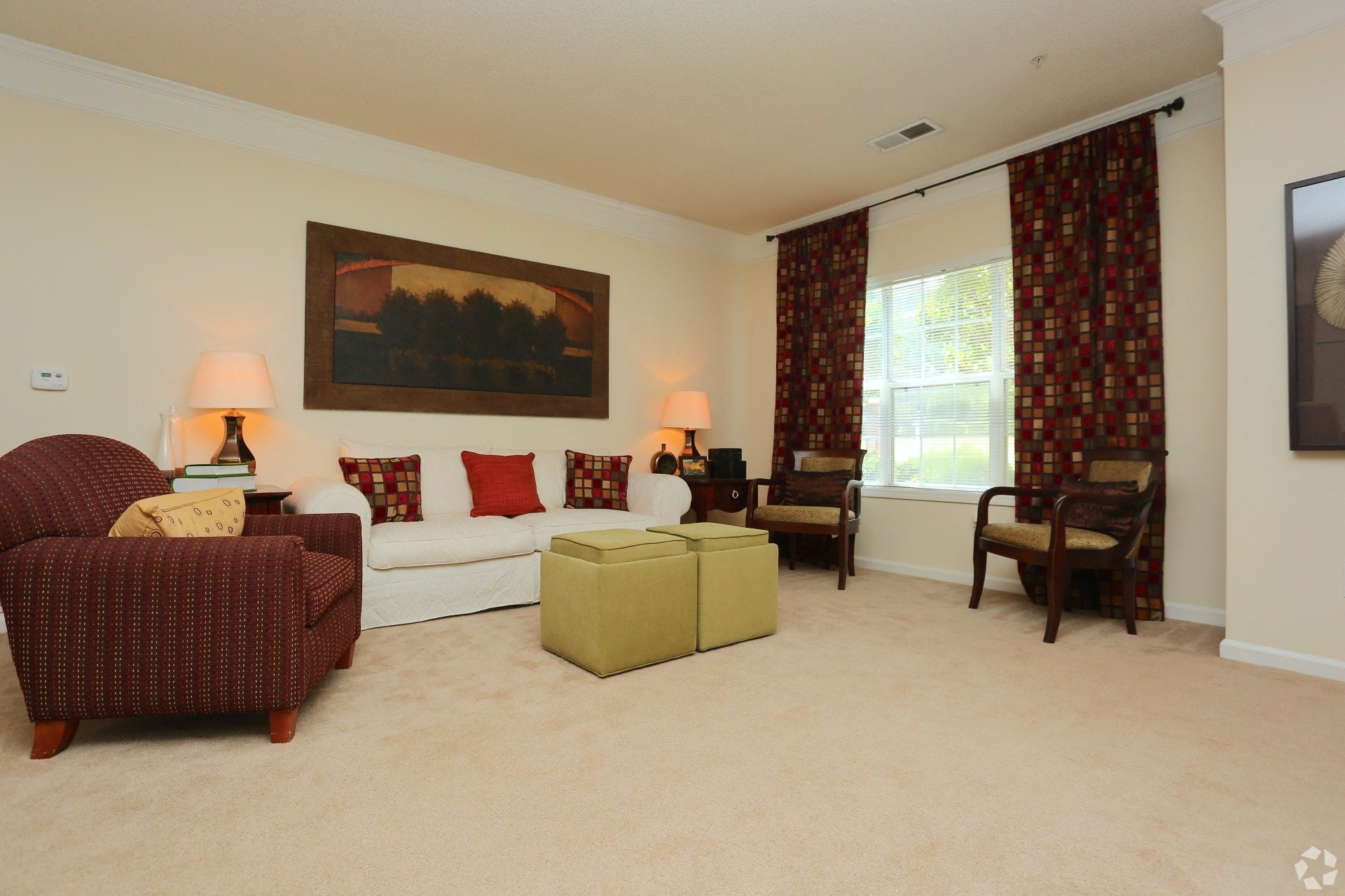 a living room with a couch and a chair and a window